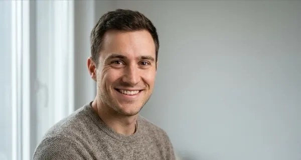 Example lead photo: a smiling man in soft window light, chest-up framing