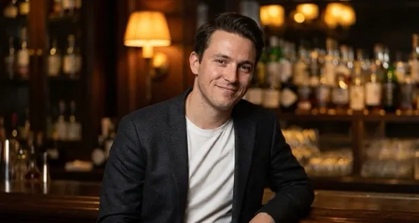Example dressed-up photo: a man in a blazer in warm bar lighting